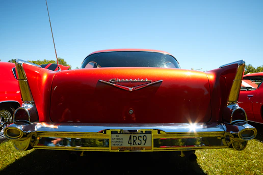 A gleaming 1948 Chevy Stylemaster Sports Coupe parked on a sunlit country road, capturing its timeless charm.