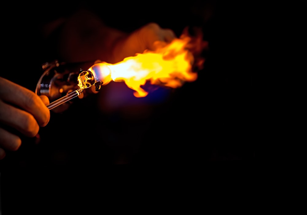 person holding grey lit torch