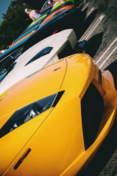 A row of sporty cars lined up at a dealership lot