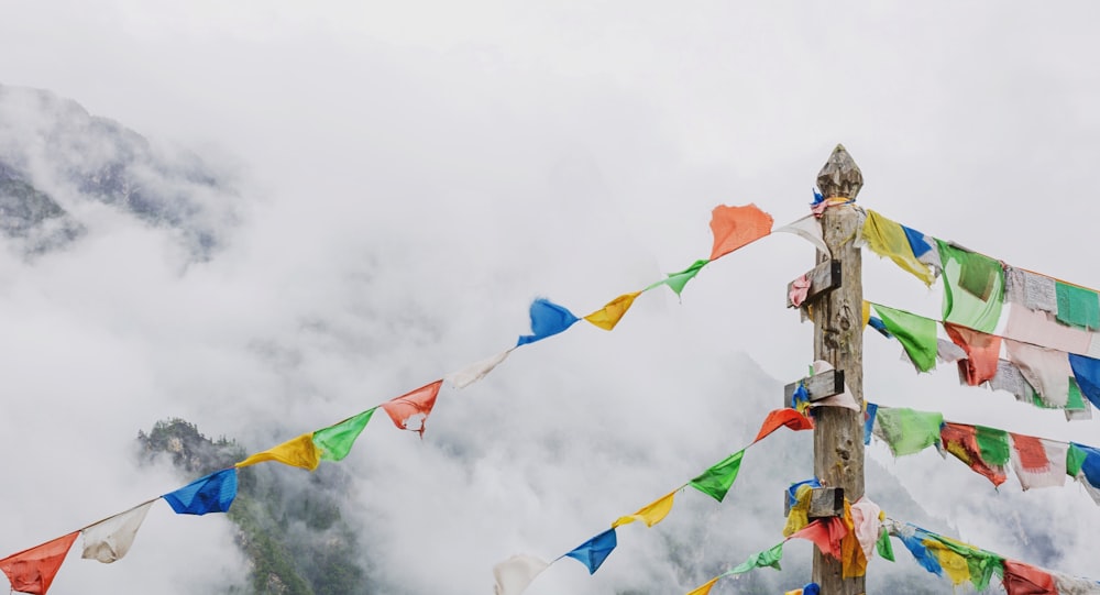 pole with flaglets under white clouds