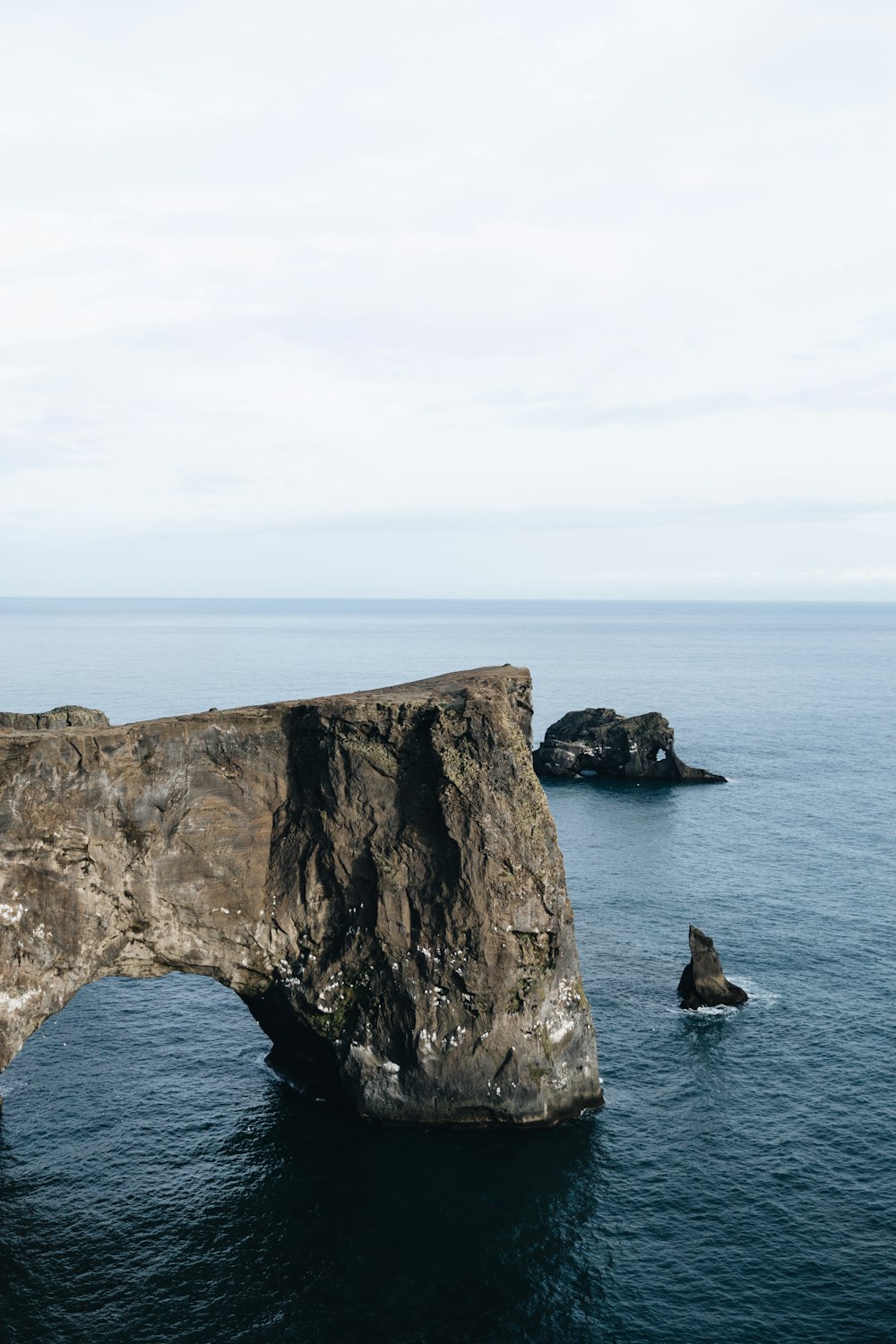 brown rock formation near sea at daytime