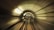 High-speed view inside a futuristic tunnel with curved walls and motion blur effect, giving a sense of fast movement and depth.