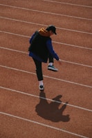 man walking on track field