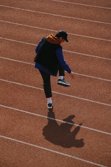 man walking on track field