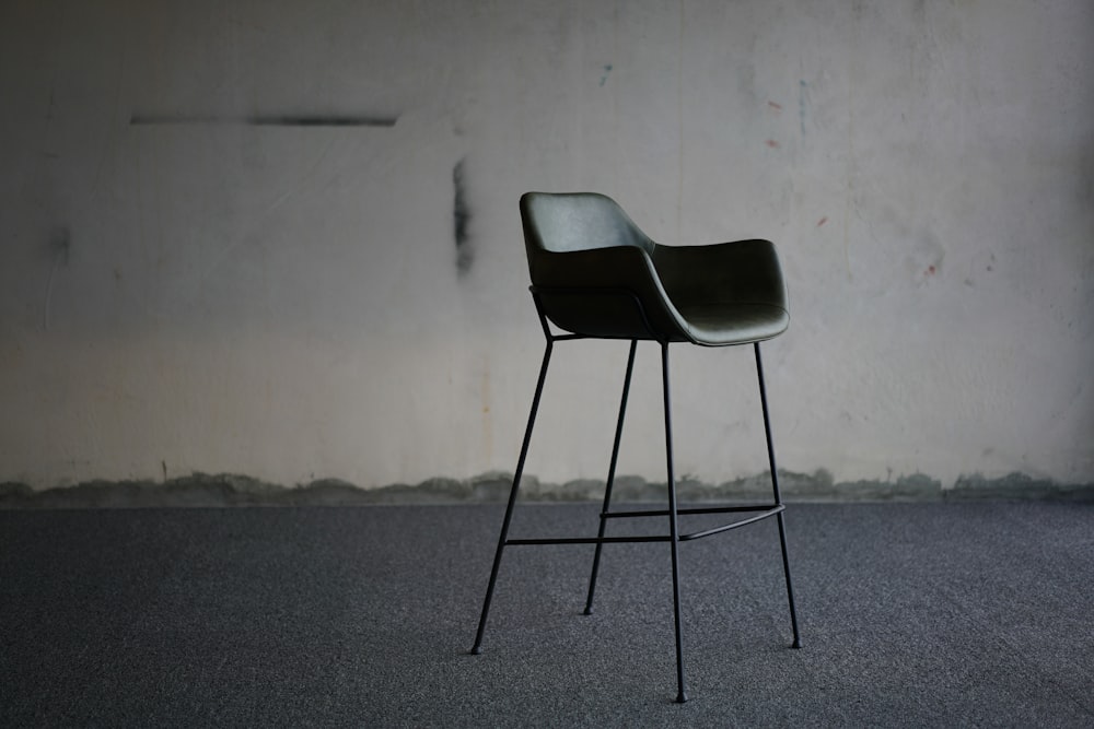 black armchair beside wall