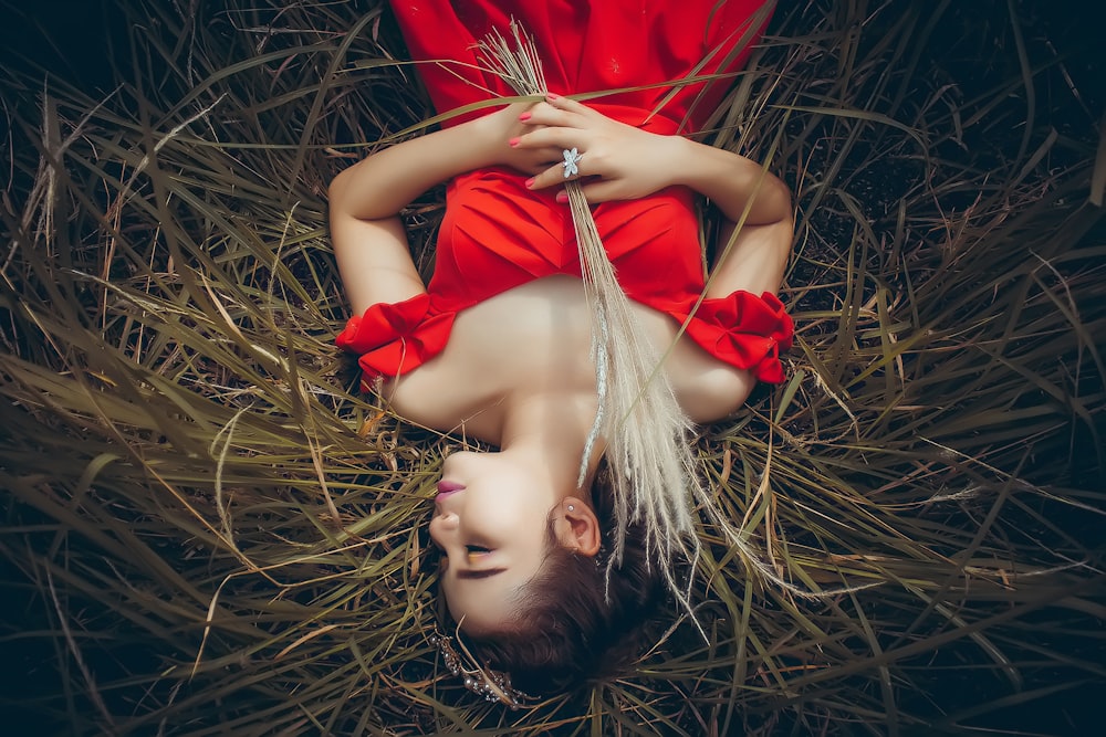 woman lying on green grass field