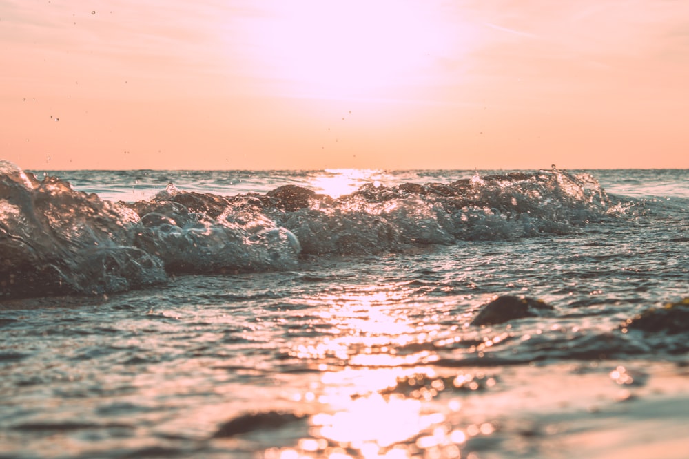 low-angle photography of crashing sea waves