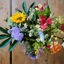 assorted-color flowers on brown wood