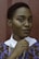 women holding her collar standing near wall