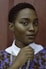 women holding her collar standing near wall