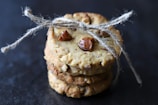 Artfully stacked Nutricely cookies with visible nuts and grains.