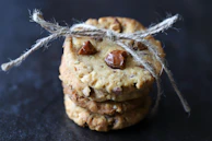 Stacked oatmeal cookies tied with a rustic string on a linen cloth.