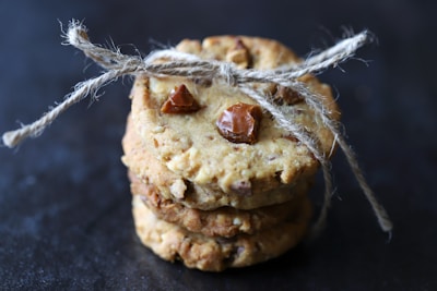 Artfully stacked Nutricely cookies with visible nuts and grains.