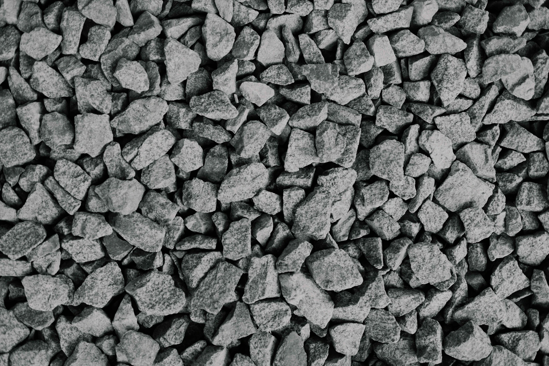 Close texture of dark crushed gravel aggregate