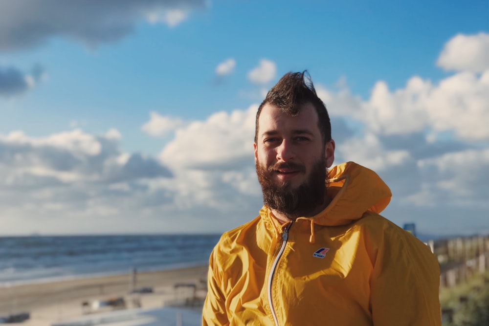 man wearing yellow zip-up jacket