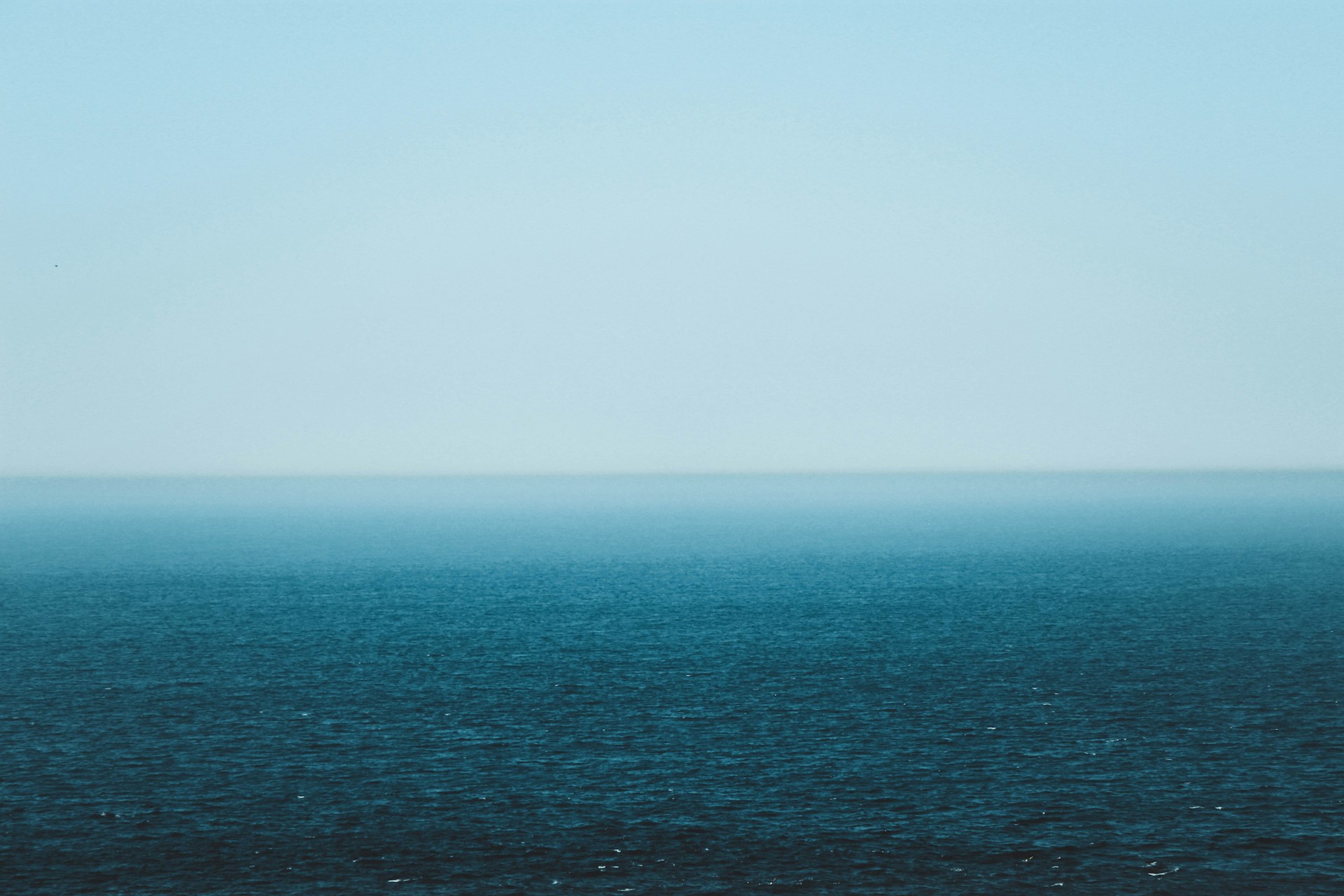body of water under gray skies