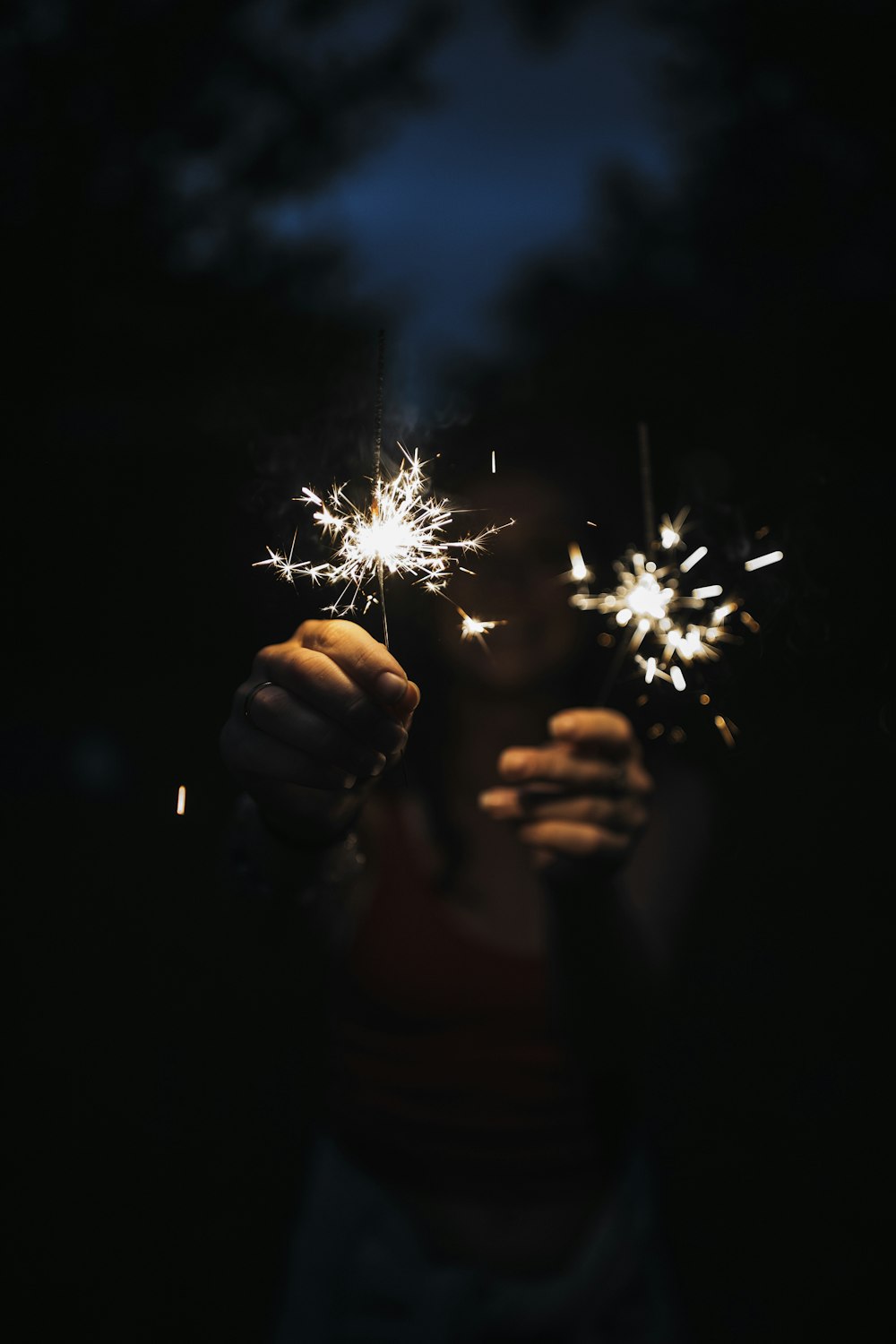 person holding firecrackers during nighttime