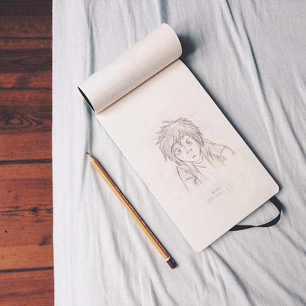 An artistic sketchbook open to colorful, imaginative character designs.