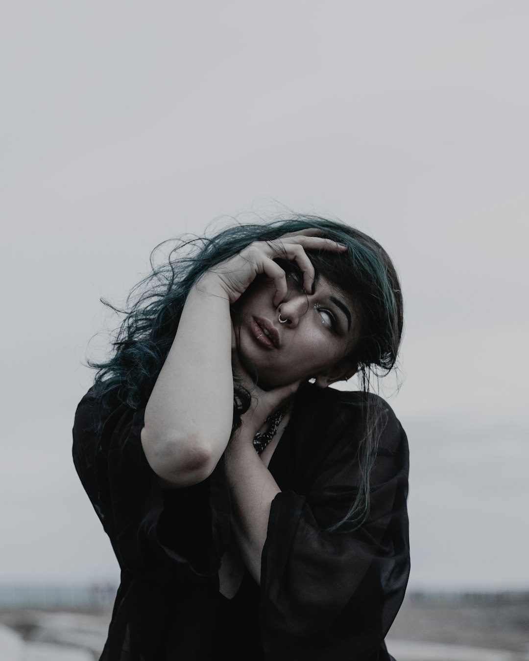 woman wearing black long-sleeved top while standing