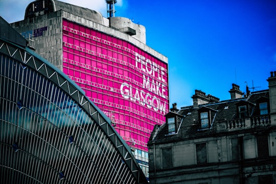 low angle view of building with People make Glasgow billboard in George Square United Kingdom