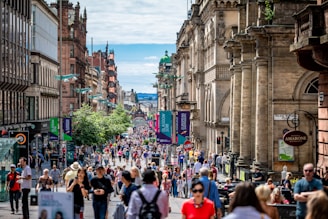 people walking between concrete buildings at daytime