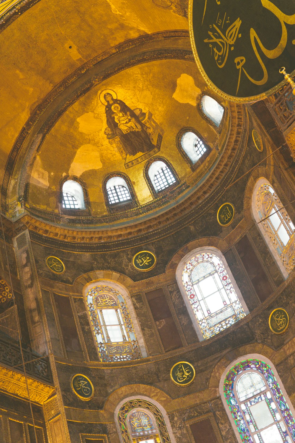 the inside of a building with a dome and stained glass windows