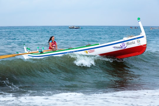 woman riding on white boat in Rincón de la Victoria Spain