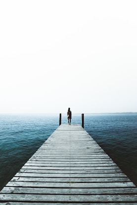 woman standing on water dock
