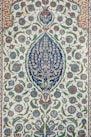 an intricately designed rug with blue and green flowers