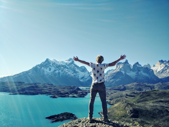 men's white and black t-shirt in Torres del Paine National Park Chile