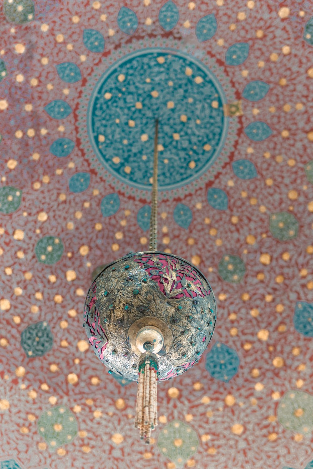 the ceiling of a room with a chandelier hanging from it's ceiling