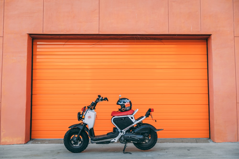 black helmet on white automatic motor cycle