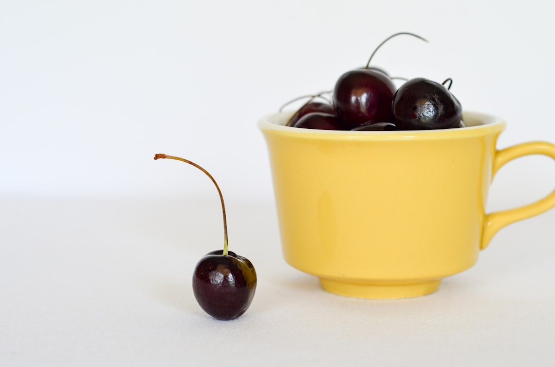 red cherry on yellow cup