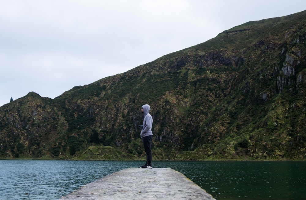 man standing near body of water