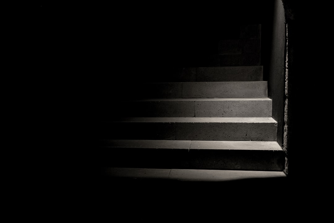  person taking photo of grey concrete stairs stairs