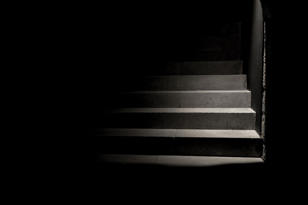 person taking photo of grey concrete stairs