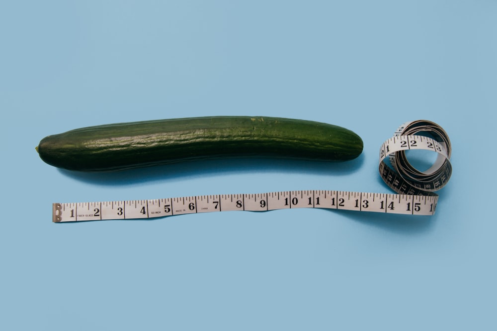 gourd and white tape measure on blue surface