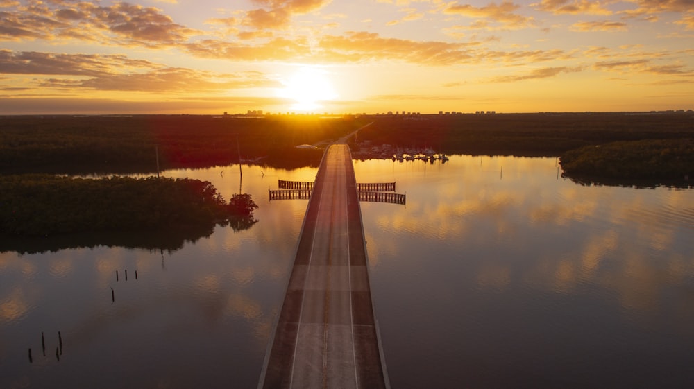 landscape photography of a bridge between body of water during golden hour