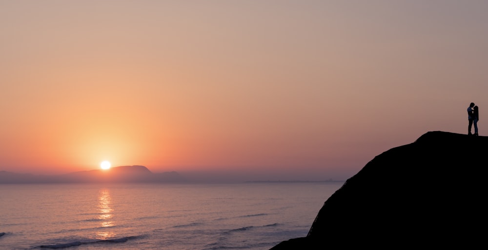 silhouette of man and hill