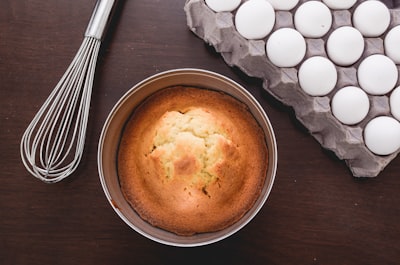 baked muffins beside tray of eggs and whisker cornbread teams background