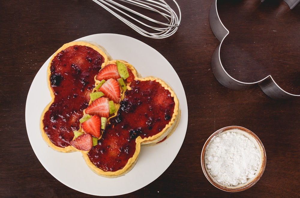 bread with strawberry jam and sliced strawberries