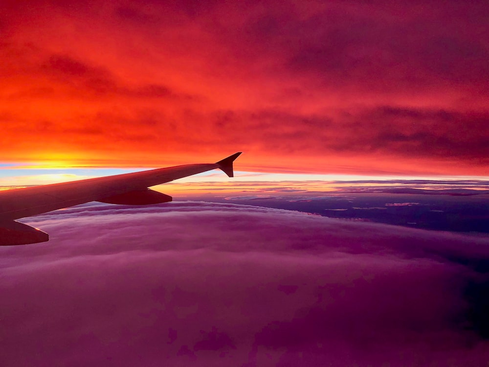 right plane wing photo of bed of clouds