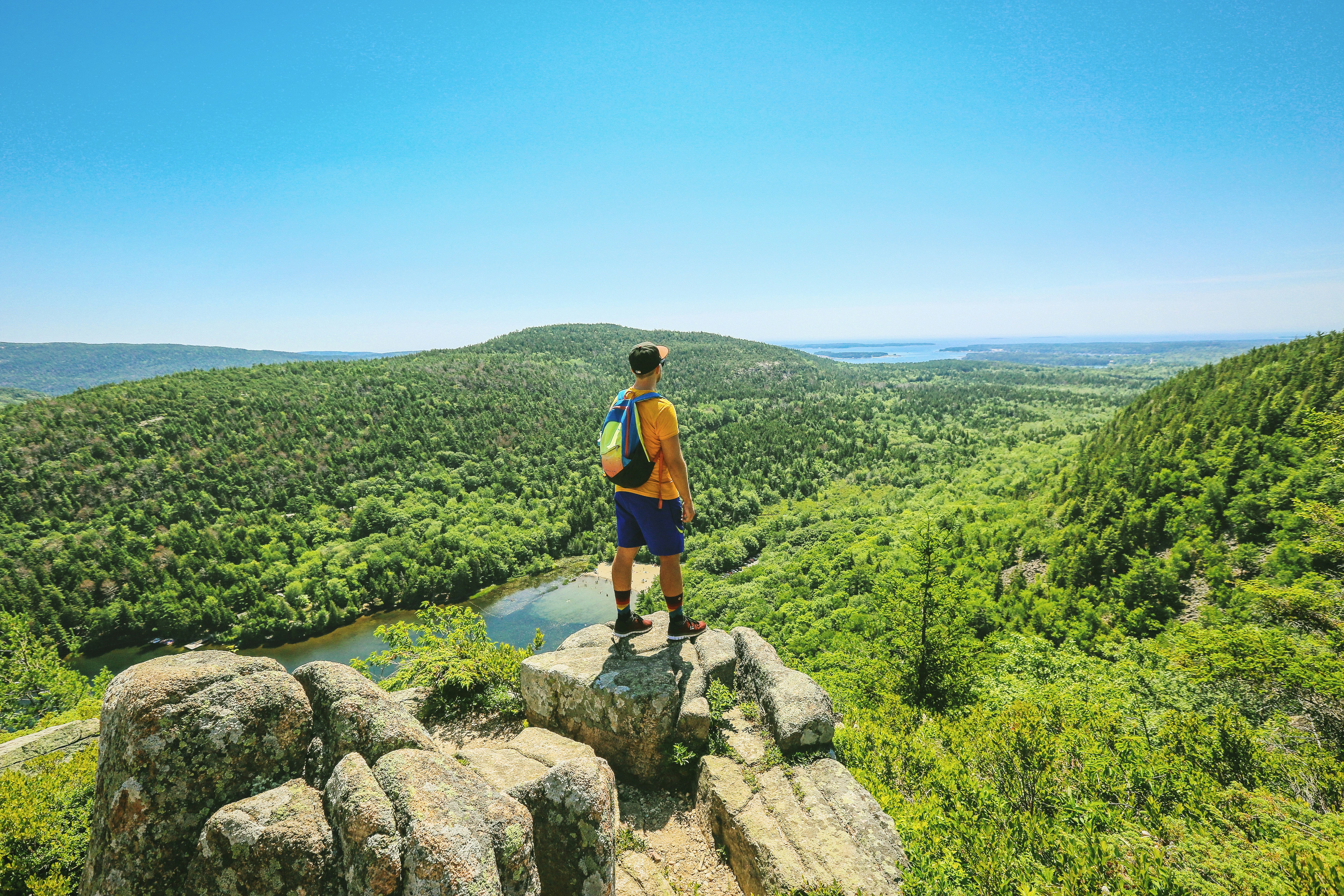man on top of hill looking downward