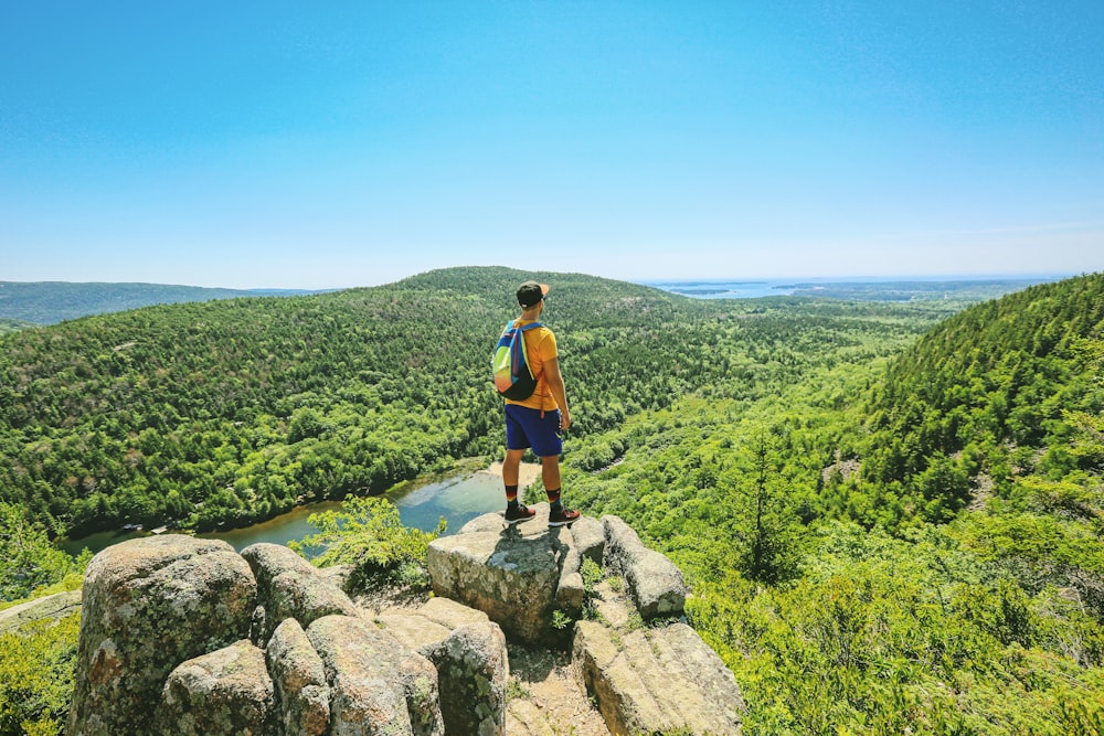 man on top of hill looking downward