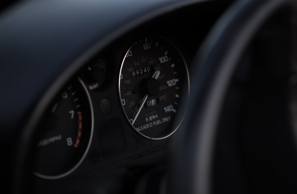 black vehicle speedometer