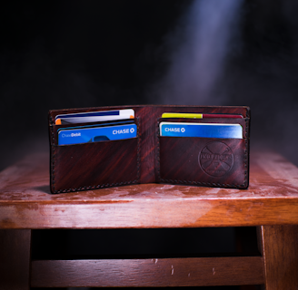 brown leather bifold wallet on table