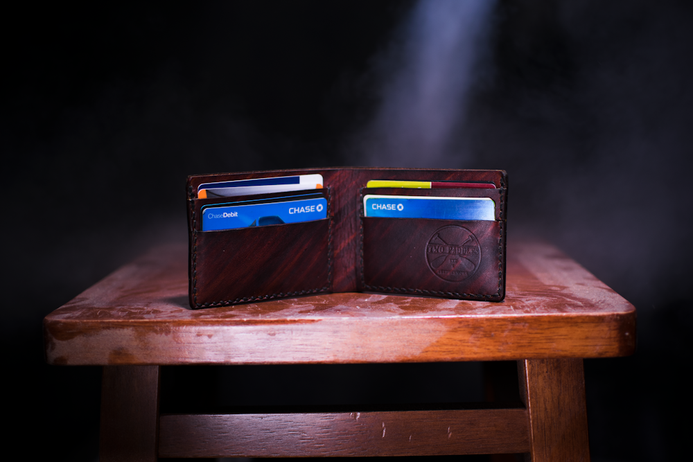 brown leather bifold wallet on table