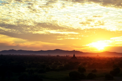 Jami and Kim capturing sunset hues over an ancient temple during their travels.