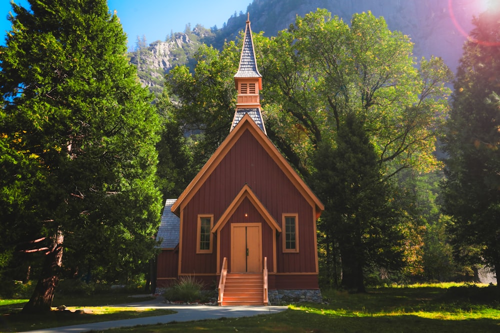 brown chapel surrounded with trees