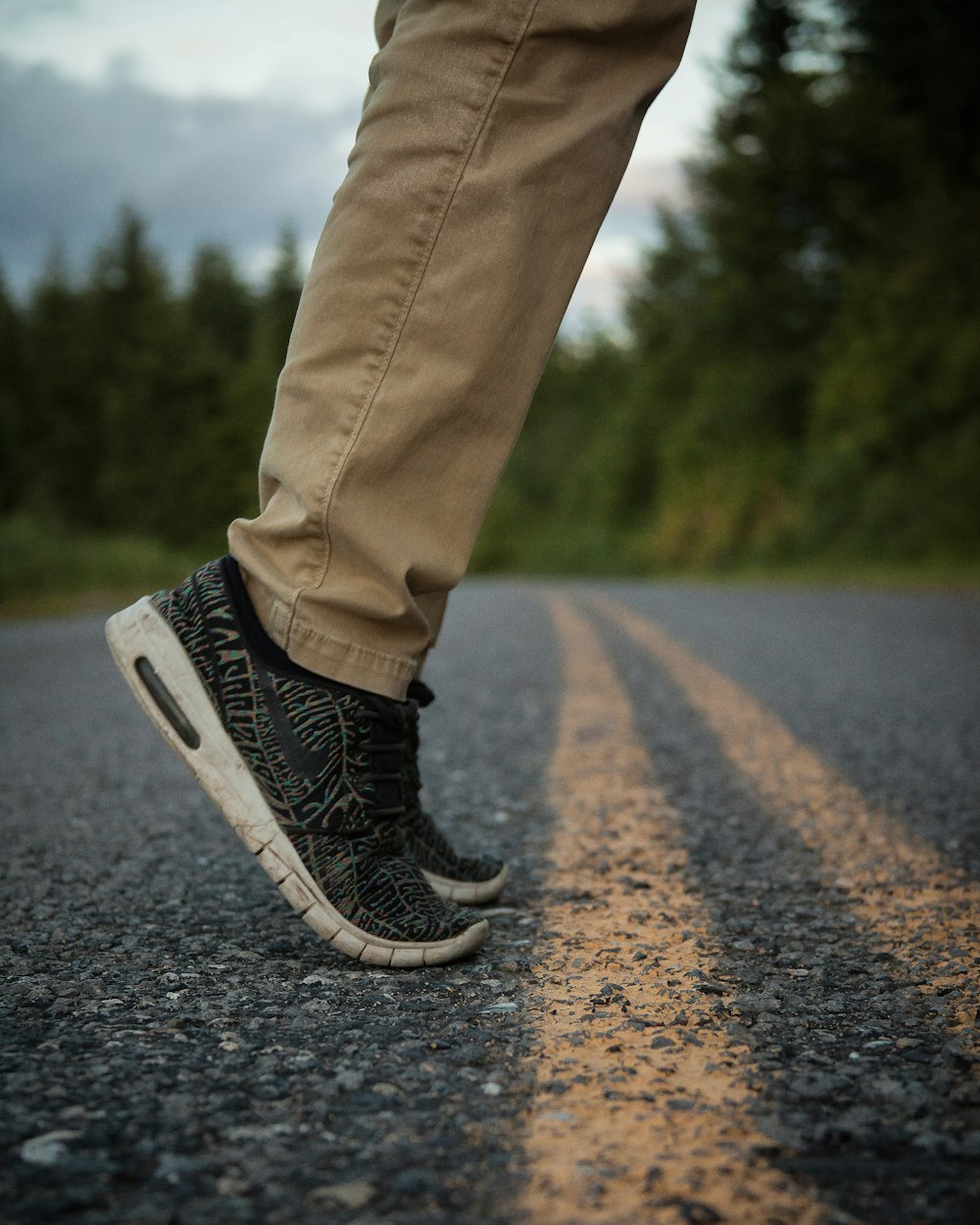 Person in brauner Hose steht auf der Straße